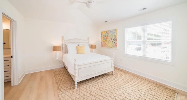 bedroom featuring light wood-type flooring, visible vents, baseboards, and ceiling fan