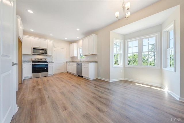22 Lochwood Hill Dr, Goode, VA 24556 - kitchen featuring appliances with stainless steel finishes, light wood-style floors, baseboards, white cabinetry, and recessed lighting