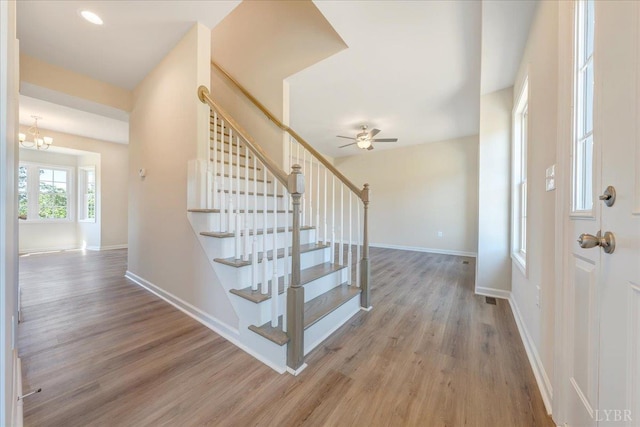 22 Lochwood Hill Dr, Goode, VA 24556 - foyer entrance featuring wood finished floors, stairs, baseboards, and a chandelier