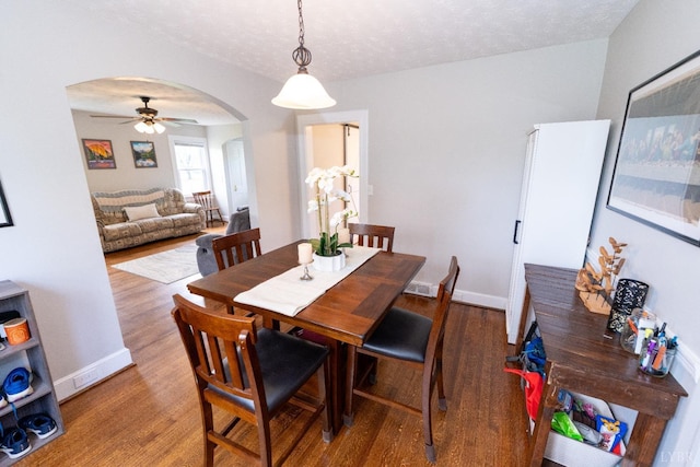 299 Alum Springs Rd, Lynchburg, VA 24502 - dining room featuring arched walkways, wood finished floors, ceiling fan, baseboards, and a textured ceiling