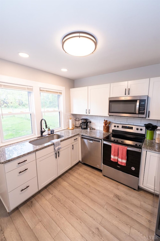 299 Alum Springs Rd, Lynchburg, VA 24502 - kitchen featuring appliances with stainless steel finishes, a sink, white cabinets, light stone countertops, and recessed lighting