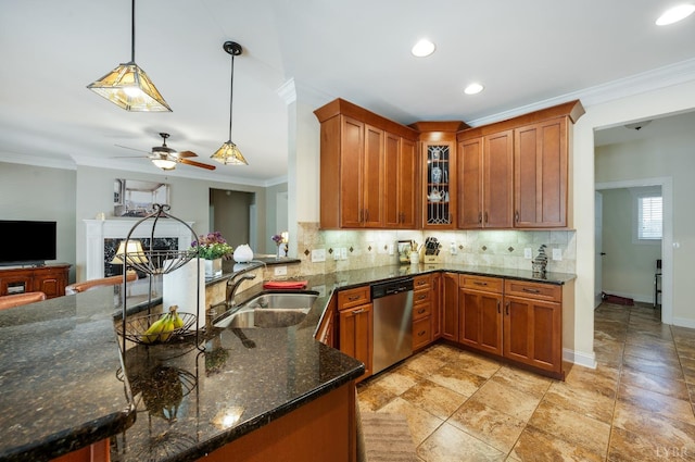 1310 Whispering Springs Ct, Forest, VA 24551 - kitchen featuring a sink, a fireplace, brown cabinetry, decorative backsplash, and stainless steel dishwasher