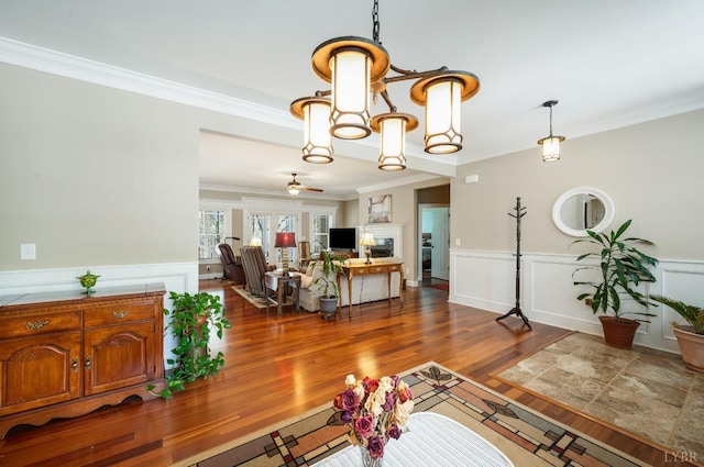 1310 Whispering Springs Ct, Forest, VA 24551 - living area featuring crown molding, wainscoting, a decorative wall, a chandelier, and dark wood-style floors