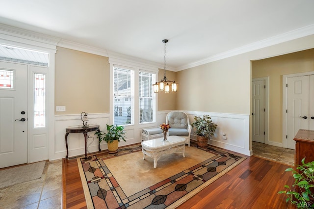 1310 Whispering Springs Ct, Forest, VA 24551 - entryway featuring crown molding, wainscoting, a decorative wall, a chandelier, and wood finished floors