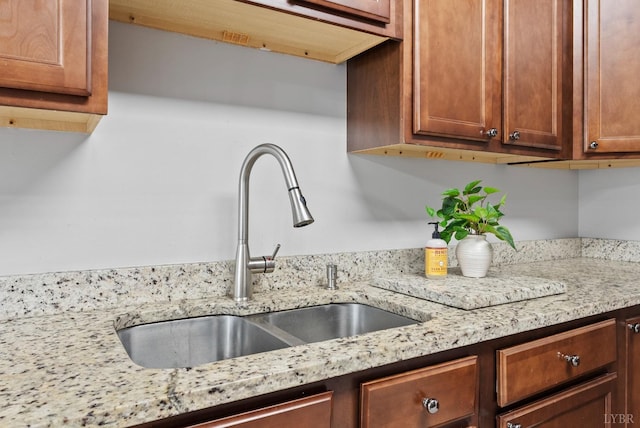 5712 Cottontown Rd, Forest, VA 24551 - kitchen with a sink, light stone countertops, and brown cabinetry