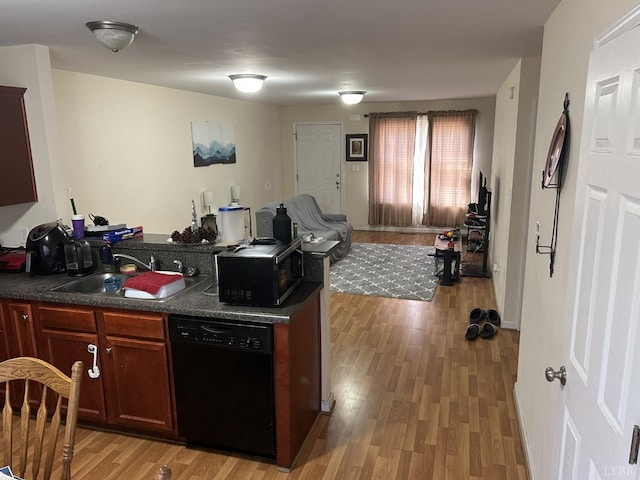 1810 Broadway St Unit 216, Lynchburg, VA 24501 - kitchen with light wood finished floors, dark countertops, a sink, black appliances, and open floor plan