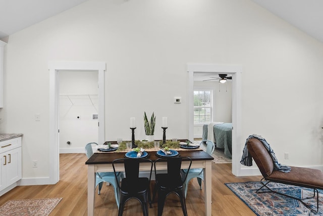 893 Cedar Gate Rd, Monroe, VA 24574 - dining room featuring high vaulted ceiling, light wood-style floors, ceiling fan, and baseboards