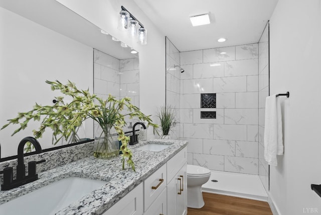 893 Cedar Gate Rd, Monroe, VA 24574 - bathroom featuring toilet, wood finished floors, a tile shower, and double vanity