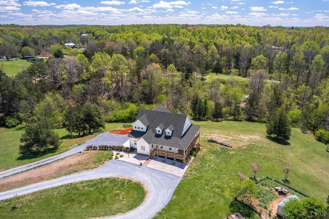 birds eye view of property featuring a wooded view