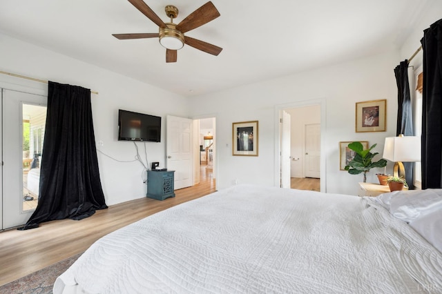 bedroom with baseboards, access to outside, wood finished floors, and a ceiling fan