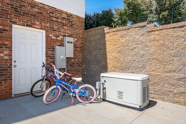 exterior space with brick siding, a power unit, and electric meter