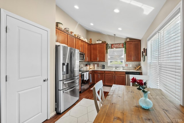255 Traverse Dr, Evington, VA 24550 - kitchen with stainless steel appliances, decorative backsplash, wood finished floors, lofted ceiling, and light countertops