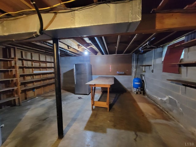 1418 Mitchell Rd, Chatham, VA 24531 - unfinished below grade area with freestanding refrigerator and a water pressure tank