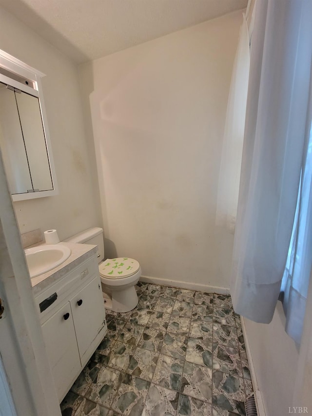 1418 Mitchell Rd, Chatham, VA 24531 - half bathroom featuring stone finish floor, baseboards, toilet, and vanity