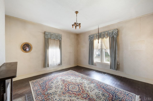 119 Harrison St, Lynchburg, VA 24504 - unfurnished dining area with visible vents, baseboards, an inviting chandelier, and wood-type flooring