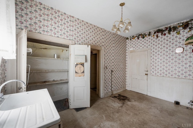 119 Harrison St, Lynchburg, VA 24504 - interior space with wainscoting, an inviting chandelier, a sink, and wallpapered walls