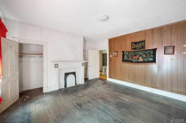 119 Harrison St, Lynchburg, VA 24504 - unfurnished living room featuring wood-type flooring, wood walls, baseboards, and a fireplace