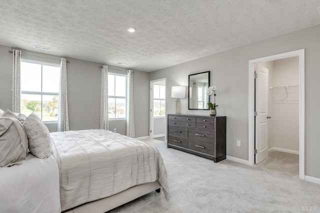 84 Kade Ct, Lynchburg, VA 24502 - bedroom with a textured ceiling, a spacious closet, baseboards, and light colored carpet