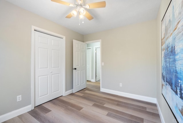 442 W King St, Bedford, VA 24523 - unfurnished bedroom featuring wood finished floors, a closet, baseboards, and ceiling fan