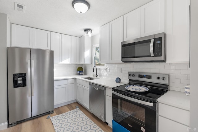 442 W King St, Bedford, VA 24523 - kitchen featuring white cabinets, visible vents, appliances with stainless steel finishes, and a sink