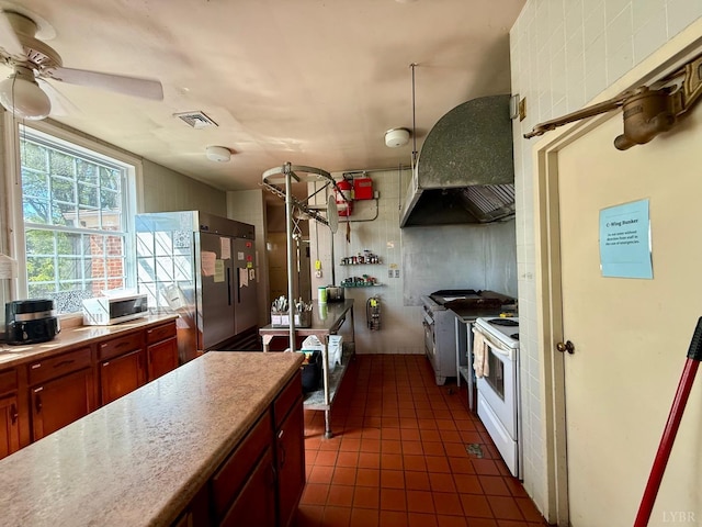2134 Westerly Dr, Lynchburg, VA 24501 - kitchen with stainless steel appliances, light countertops, visible vents, extractor fan, and dark tile patterned flooring