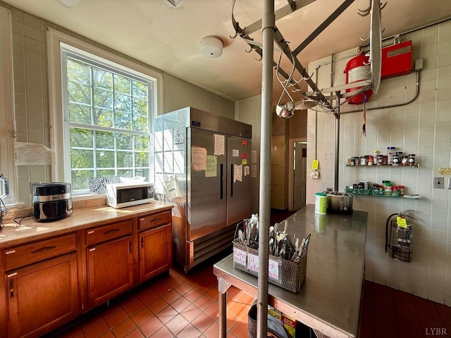 2134 Westerly Dr, Lynchburg, VA 24501 - kitchen with brown cabinetry, tile walls, stainless steel built in fridge, light countertops, and dark tile patterned floors