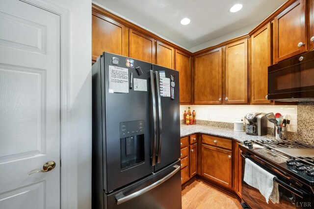 328 Paulette Cir, Lynchburg, VA 24502 - kitchen featuring black appliances, light stone countertops, brown cabinets, recessed lighting, and backsplash