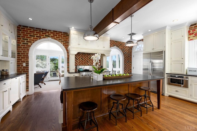 3830 Peakland Pl, Lynchburg, VA 24503 - kitchen with arched walkways, dark countertops, stainless steel appliances, and dark wood-type flooring