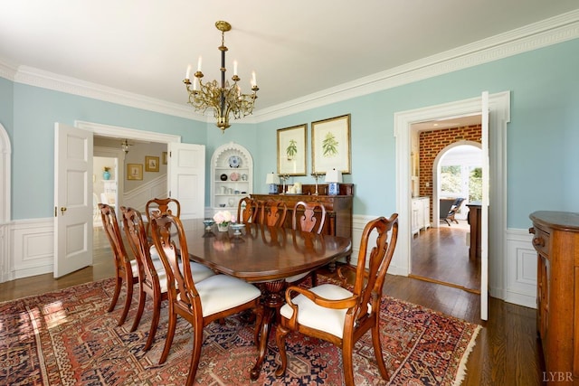 3830 Peakland Pl, Lynchburg, VA 24503 - dining area featuring ornamental molding, dark wood finished floors, built in shelves, wainscoting, and a notable chandelier