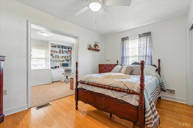 1321 Norfolk Ave, Bedford, VA 24523 - bedroom with light wood-style floors, multiple windows, a textured ceiling, a desk, and baseboards