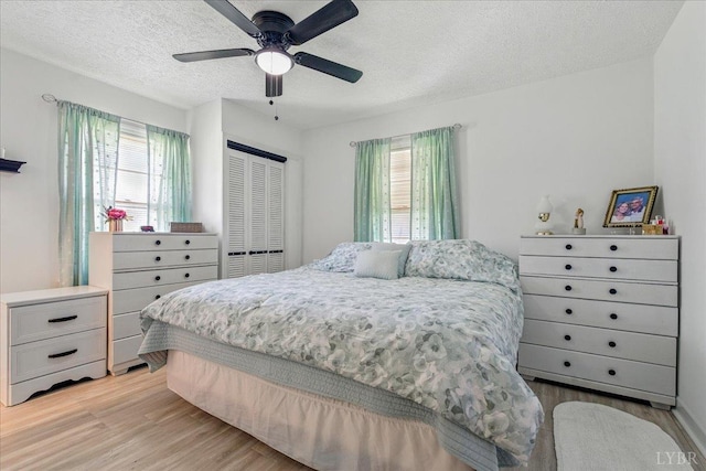 1321 Norfolk Ave, Bedford, VA 24523 - bedroom with multiple windows, light wood-style flooring, a textured ceiling, and a closet