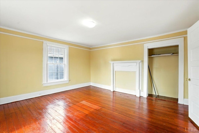 702 Dinwiddie St, Lynchburg, VA 24504 - unfurnished bedroom featuring crown molding, hardwood / wood-style floors, a closet, and baseboards