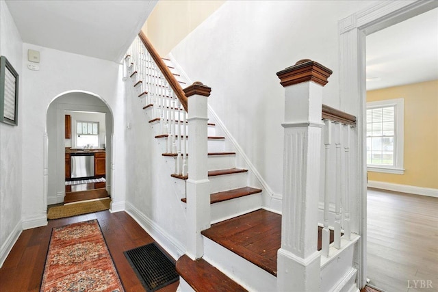702 Dinwiddie St, Lynchburg, VA 24504 - stairs featuring wood finished floors, arched walkways, and baseboards