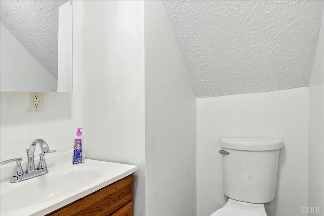 702 Dinwiddie St, Lynchburg, VA 24504 - half bathroom featuring a textured ceiling, lofted ceiling, toilet, and vanity