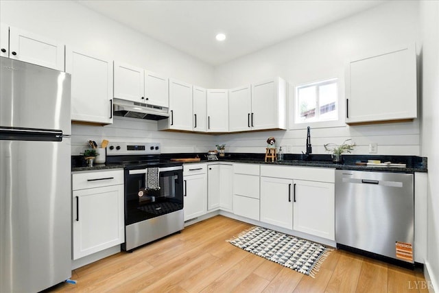 17 Beverly St, Lynchburg, VA 24501 - kitchen with appliances with stainless steel finishes, under cabinet range hood, a sink, light wood-style floors, and recessed lighting