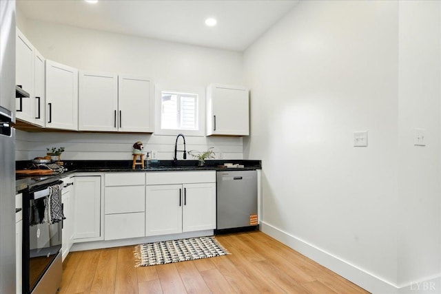 17 Beverly St, Lynchburg, VA 24501 - kitchen with dishwasher, a sink, range with electric stovetop, light wood-style floors, and white cabinets