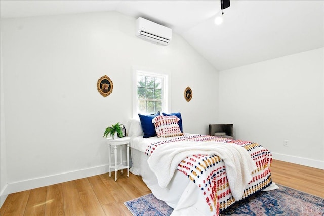 17 Beverly St, Lynchburg, VA 24501 - bedroom with an AC wall unit, vaulted ceiling, wood finished floors, and a ceiling fan