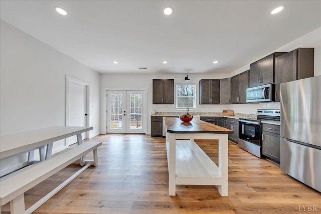 9900 Stonewall Rd, Appomattox, VA 24522 - kitchen featuring recessed lighting, stainless steel appliances, french doors, dark brown cabinetry, and decorative backsplash
