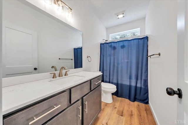 9900 Stonewall Rd, Appomattox, VA 24522 - full bath with wood finished floors, vanity, a shower with curtain, toilet, and visible vents