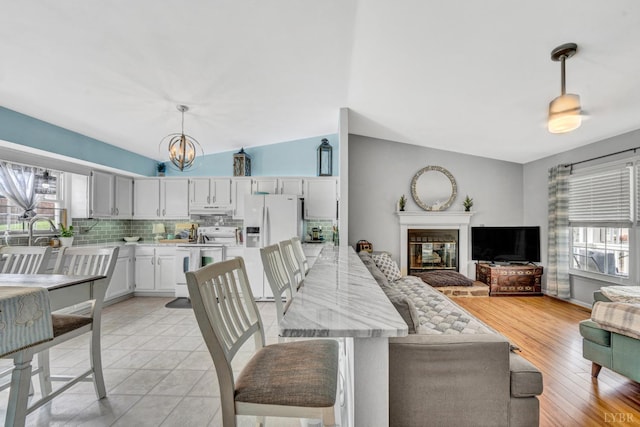 3783 Praline Pl, Roanoke, VA 24012 - dining area featuring healthy amount of natural light, a chandelier, and a glass covered fireplace
