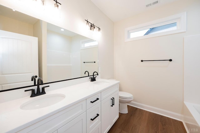 1750 Willow Oak Dr, Forest, VA 24551 - bathroom featuring a sink, baseboards, wood finished floors, and visible vents