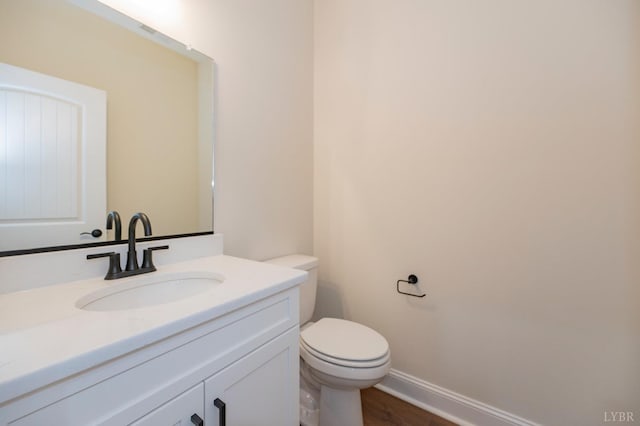 1750 Willow Oak Dr, Forest, VA 24551 - bathroom with baseboards, wood finished floors, toilet, and vanity
