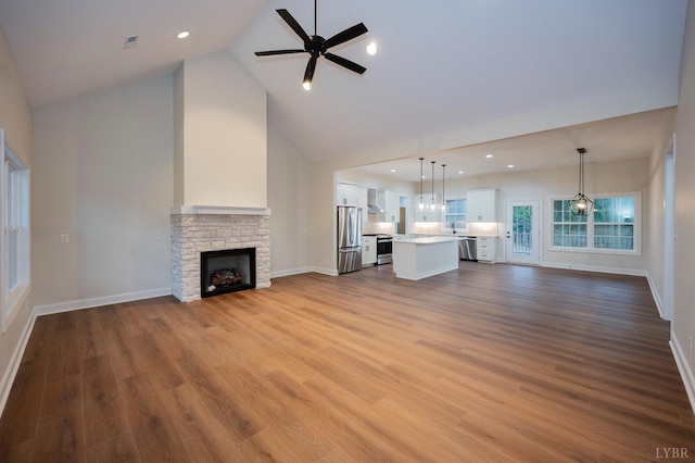 1750 Willow Oak Dr, Forest, VA 24551 - unfurnished living room featuring a stone fireplace, high vaulted ceiling, ceiling fan, and baseboards