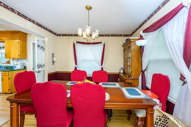 139 Old Main St, Brookneal, VA 24528 - dining space with a chandelier, light wood-style floors, and crown molding