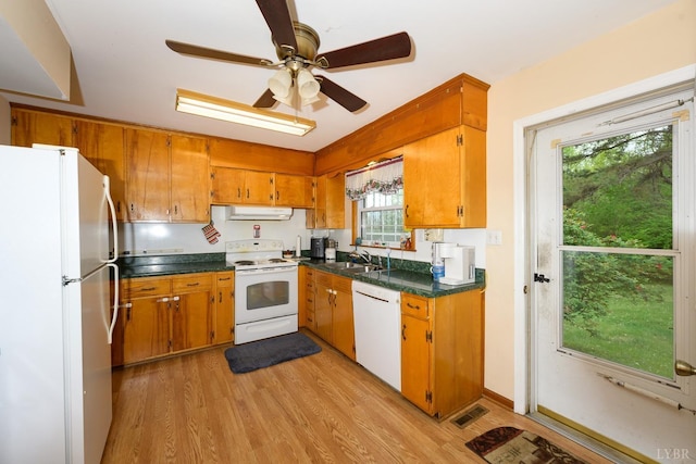 139 Old Main St, Brookneal, VA 24528 - kitchen featuring white appliances, ventilation hood, brown cabinetry, and light wood-style floors