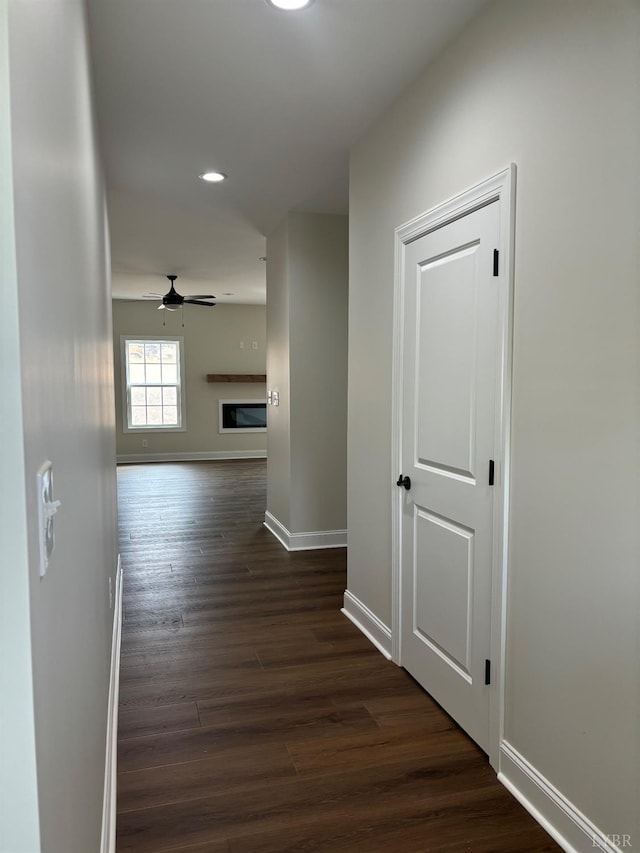 corridor featuring baseboards, dark wood-style flooring, and recessed lighting