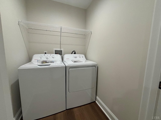 laundry area with washing machine and clothes dryer, dark wood finished floors, and baseboards