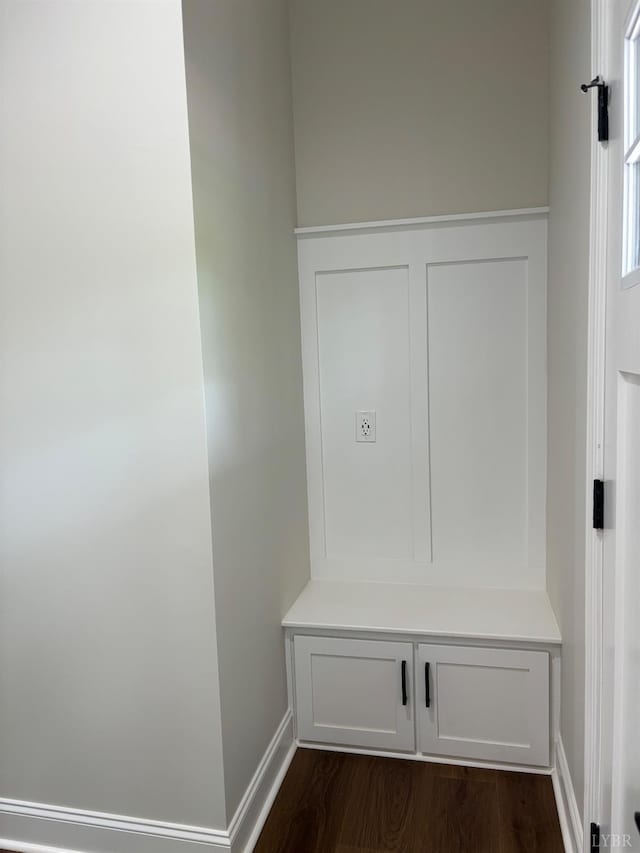 mudroom featuring dark wood finished floors and baseboards
