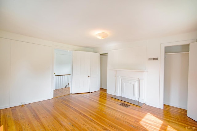 1518 14th St, Lynchburg, VA 24501 - unfurnished bedroom with multiple closets and light wood finished floors