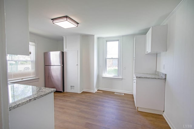 1518 14th St, Lynchburg, VA 24501 - kitchen with freestanding refrigerator, plenty of natural light, wood finished floors, and white cabinets